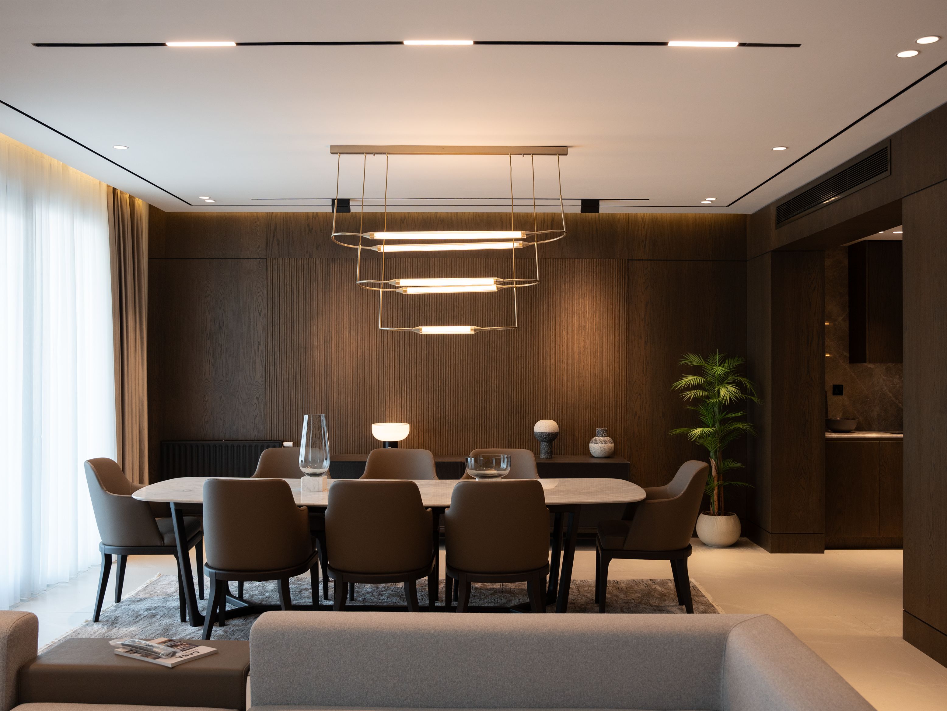 Luxury dining room with magnetic track, recessed downlights, and designer pendant lighting